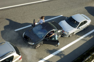 Victims of rear-end crash on highway exit vehicle after being hit from behind.