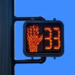 Intersection countdown timer with red hand described in California crosswalk laws.