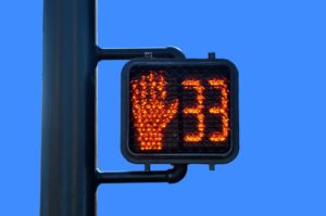 Intersection countdown timer with red hand described in California crosswalk laws.