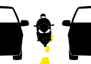 Illustration of lane splitting to prevent motorcycle injuries.