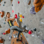 Woman Climbing Wall With Grips