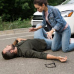 Driver Squatting Above Pedestrian After Car Accident On Road