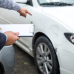 Insurance Agent Examine Damaged Car And Filing Report Claim Form