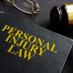 Personal Injury Law Book And A Black Desk.