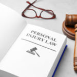 Book With Words Personal Injury Law, Gavel And Glasses On Grey B