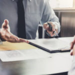 Businessman And Male Lawyer Or Judge Consult Having Team Meeting