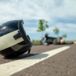 Biker Helmet Lies On Street Near A Motorcycle Accident