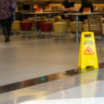 Yellow Plastic Cone With Sign Showing Warning Of Wet Floor In Re