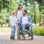 family with man in wheelchair