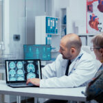 doctor and patient looking at brain scan