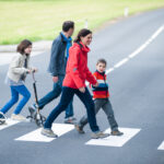 young family in crosswalk