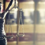 Scales-of-Justice-close-up-with-legal-books-150x150